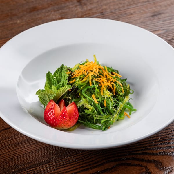 Sogo Hibachi and Sushi Lounge's seaweed salad with shredded carrots, mint, and a strawberry garnish.