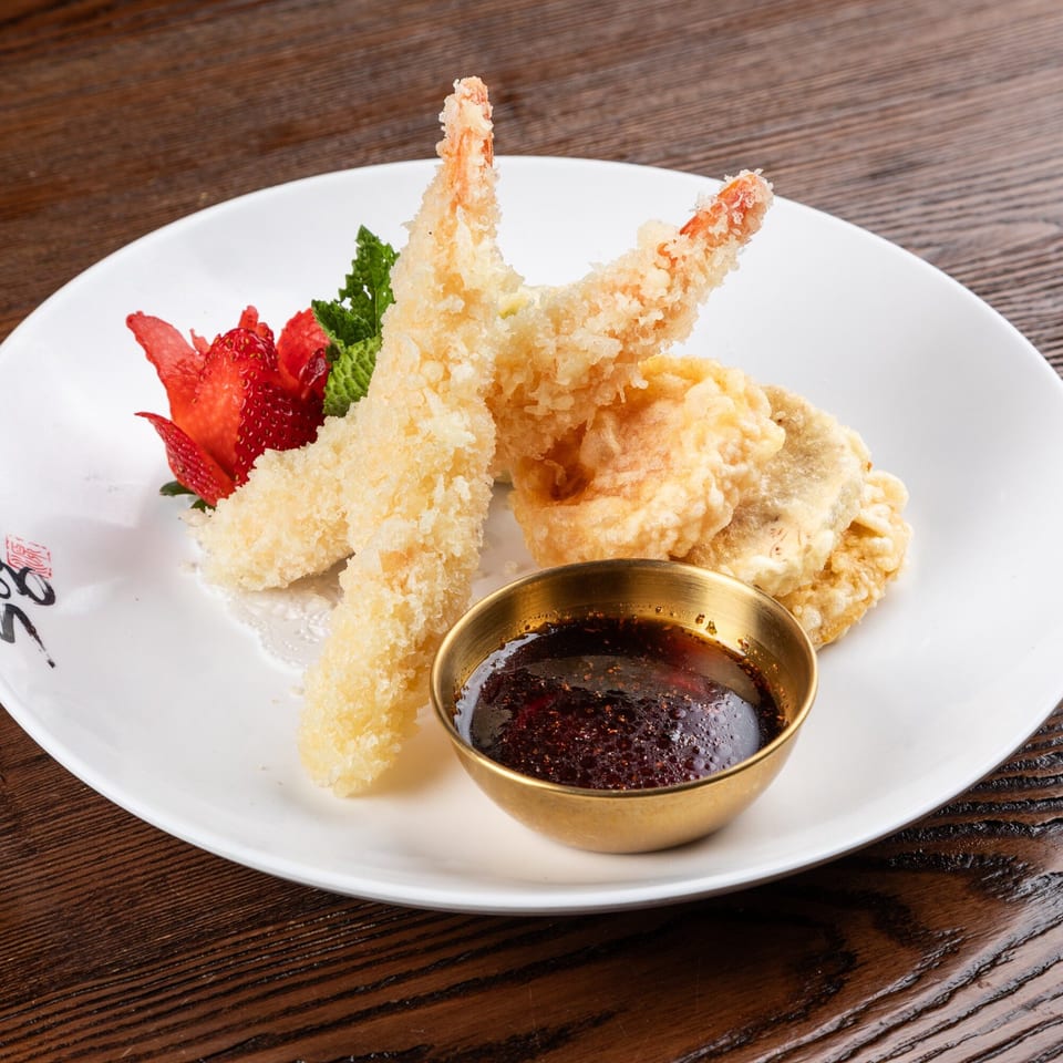 Sogo Hibachi and Sushi Lounge's shrimp tempura with dipping sauce, garnished with strawberry and mint.