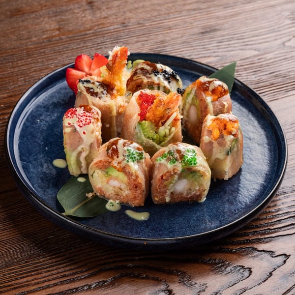 Sogo Hibachi and Sushi Lounge's fried sushi rolls with various toppings and sauces on a blue plate.