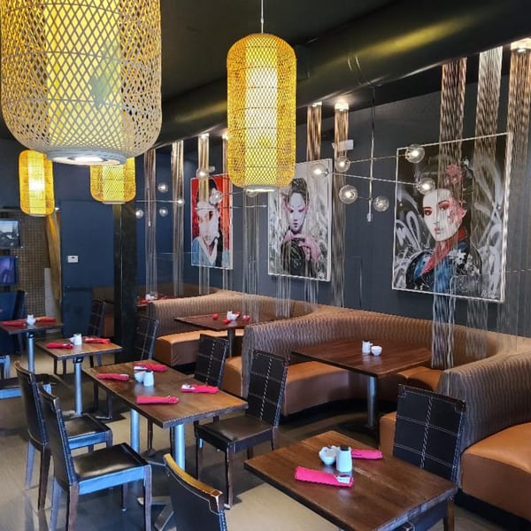 Sogo Hibachi and Sushi Lounge interior with Japanese art, bamboo lanterns, and booth seating.
