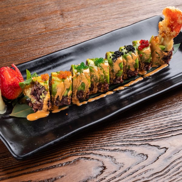 Sogo Hibachi and Sushi Lounge's sushi roll with avocado, roe, sauce, and a fried shrimp tail.