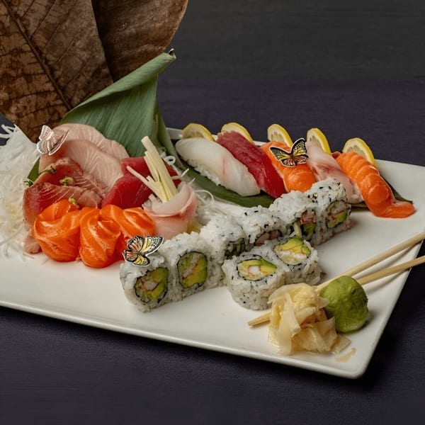A large platter of Sogo Hibachi and Sushi Lounge's sashimi, nigiri, and sushi rolls with ginger and wasabi.